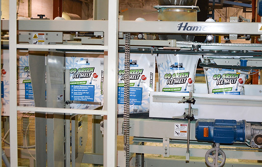 Rock salt being bagged on assembly line in manufacturing facility