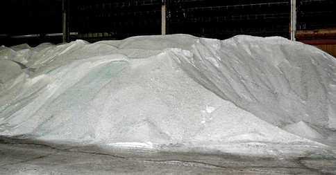 Bulk rock salt piled high in warehouse facility