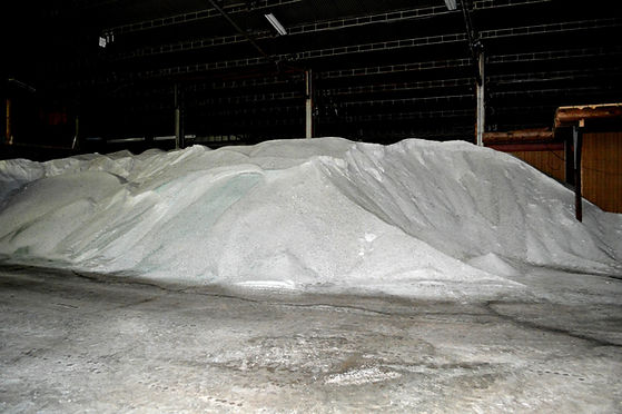 Large pile of bulk rock salt stored in warehouse