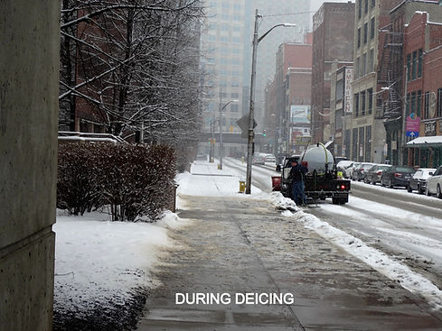 Section of snow covered sidewalk being treated with liquid deicer