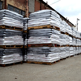 Rows upon rows of bagged rock salt on pallets in stock yard